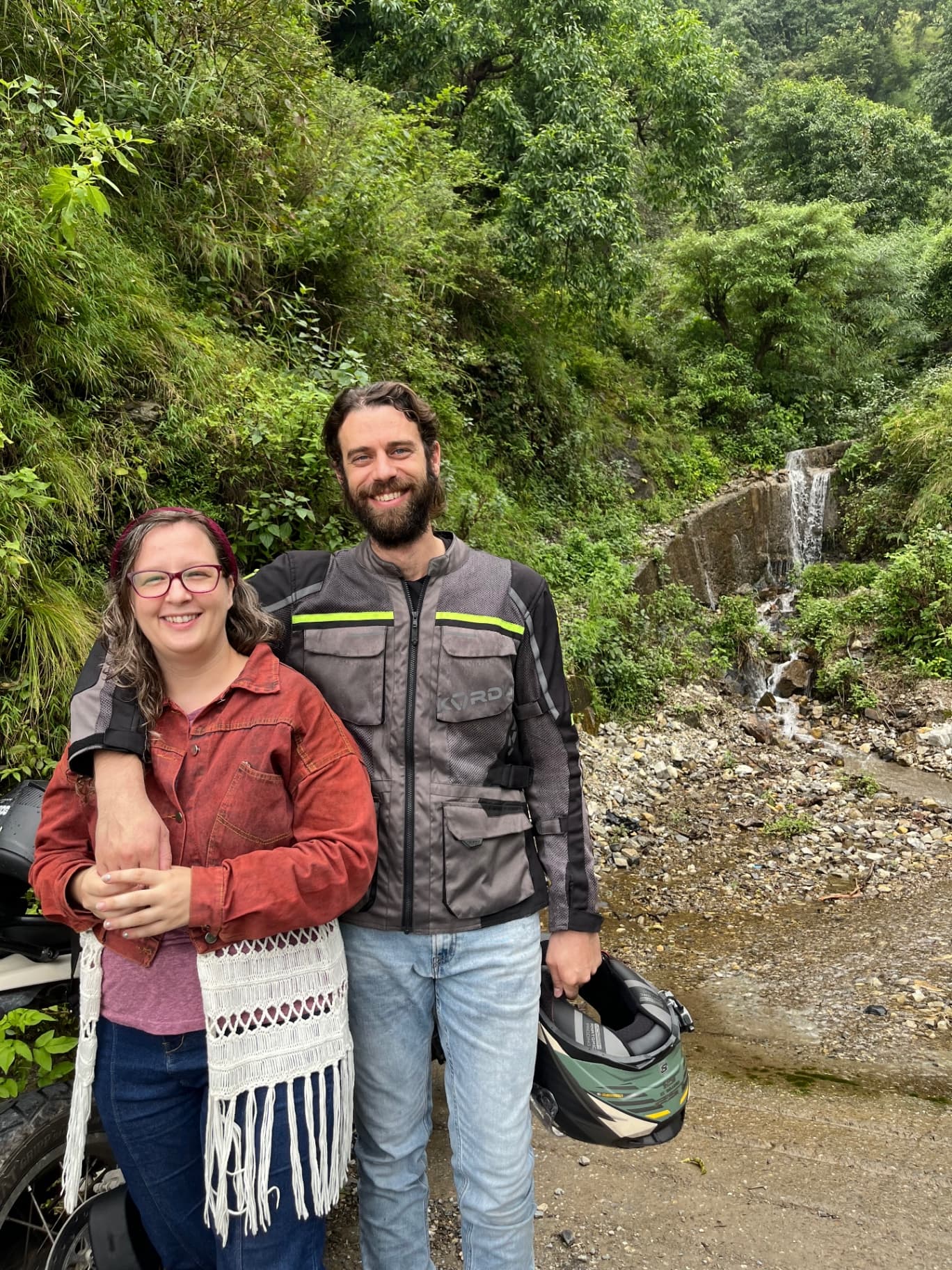 Founders of Ride Through India on their adventure with waterfall in background