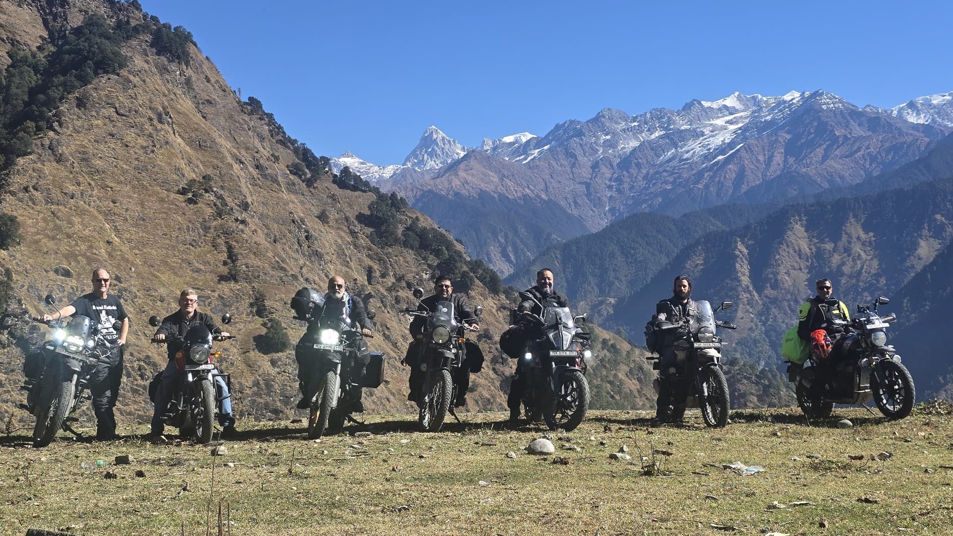 Epic Group Lineup - Our riders lined up with snow-capped peaks as backdrop